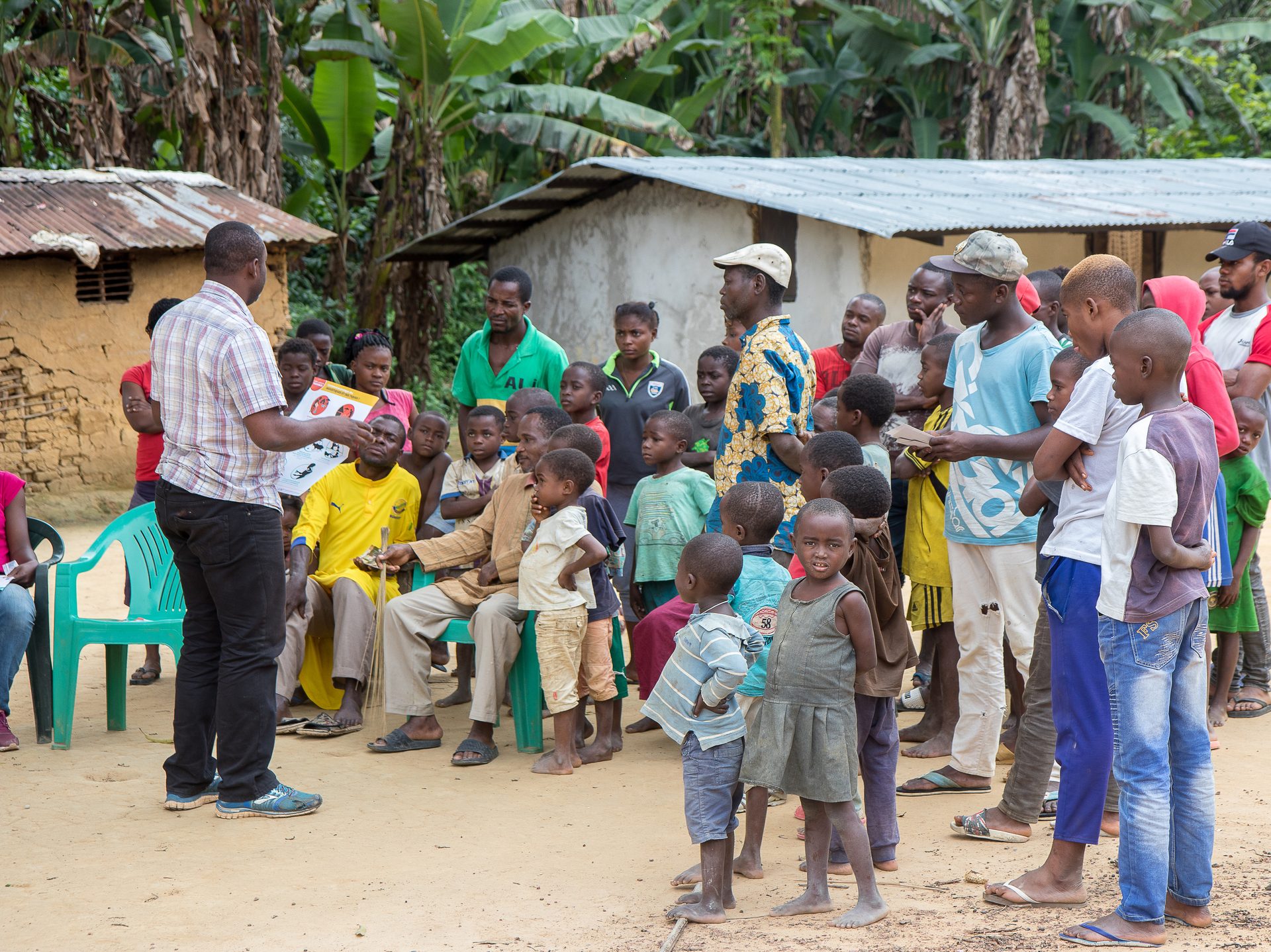 A member of the EBO-SURSY Project explains disease transmission patterns to communities in Gabon.